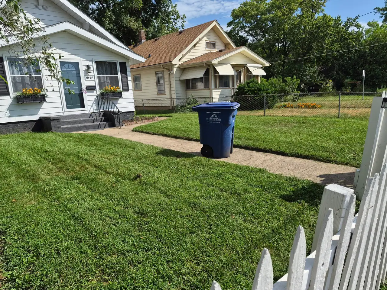 Freshly mowed front lawn with clean mowing stripes at a Des Moines home